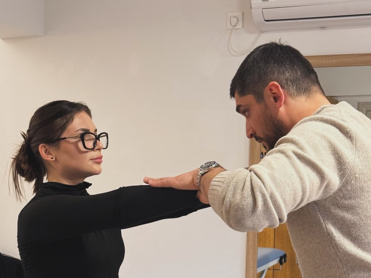 A therapist measuring how far a patient can extend an arm