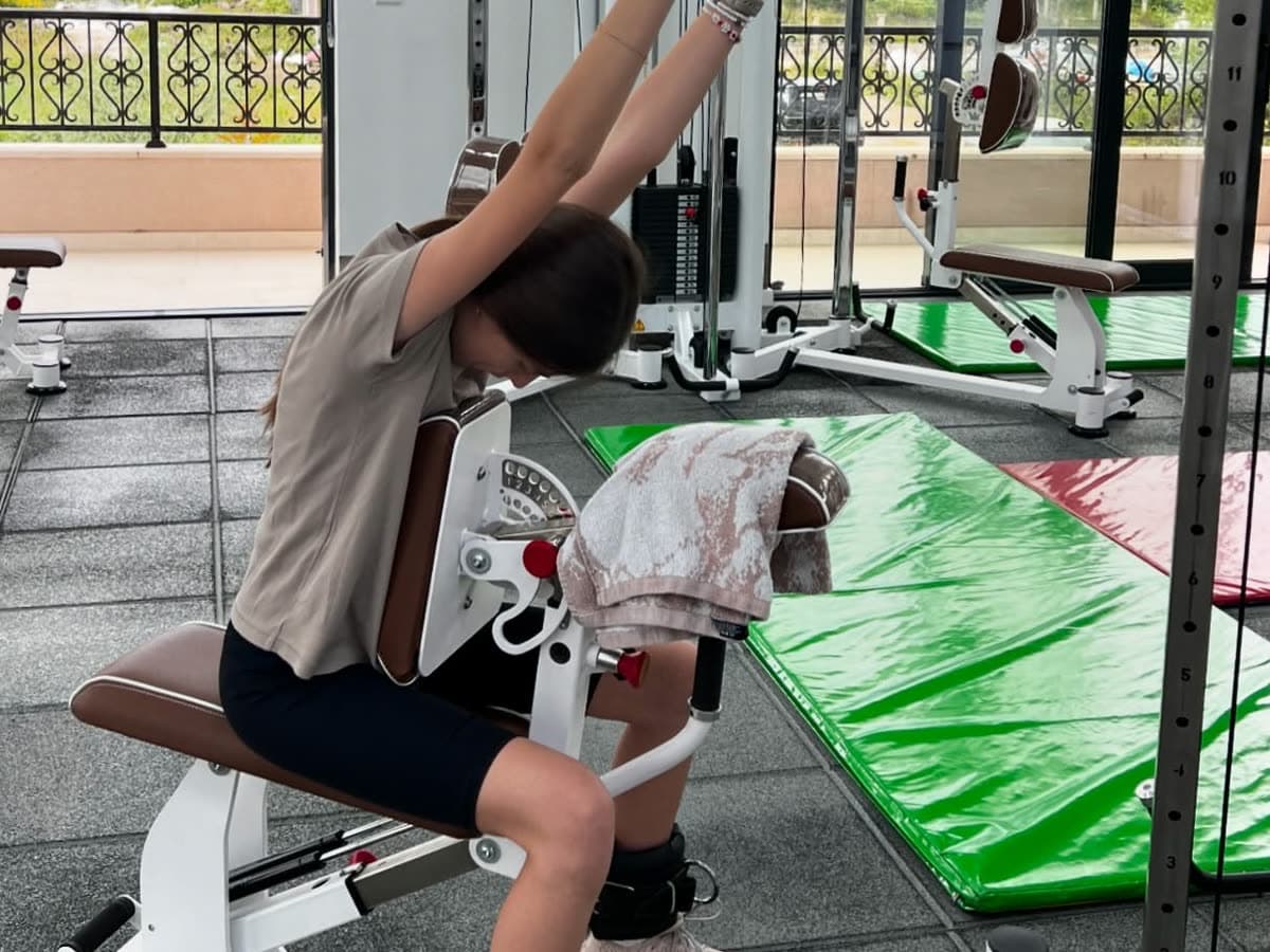 A patient working a supported extension on rehabilitation equipment